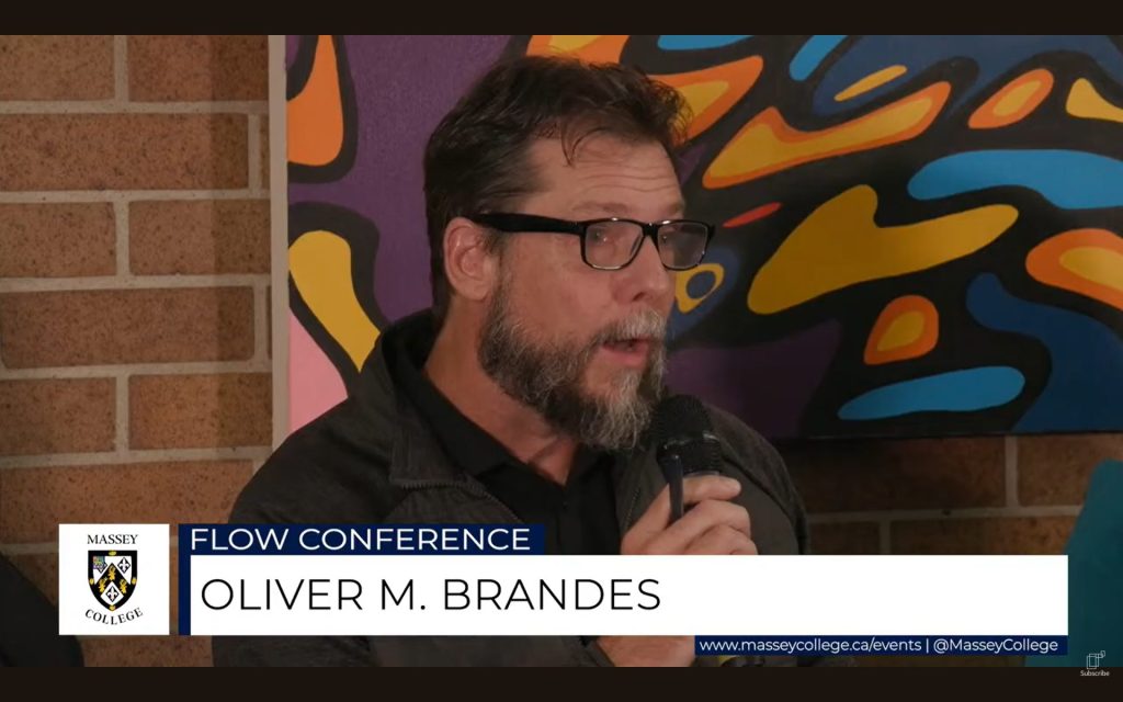 A close-up photo of POLIS Project Co-Director Oliver M. Brandes presenting at the conference.